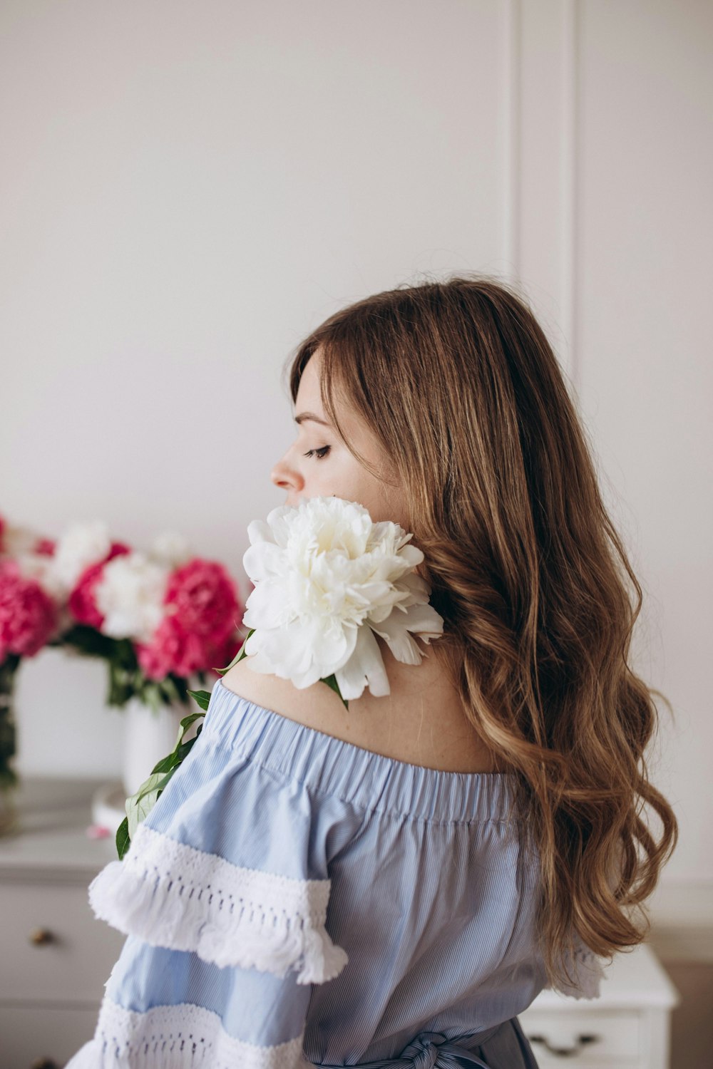 a woman holding a bouquet of flowers