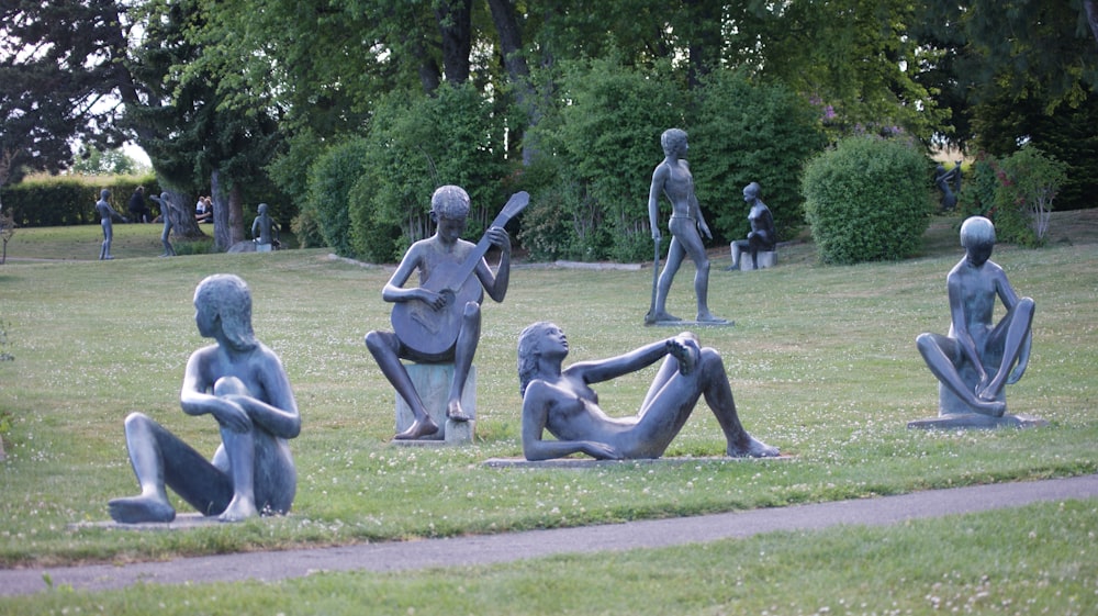 a group of statues in a park