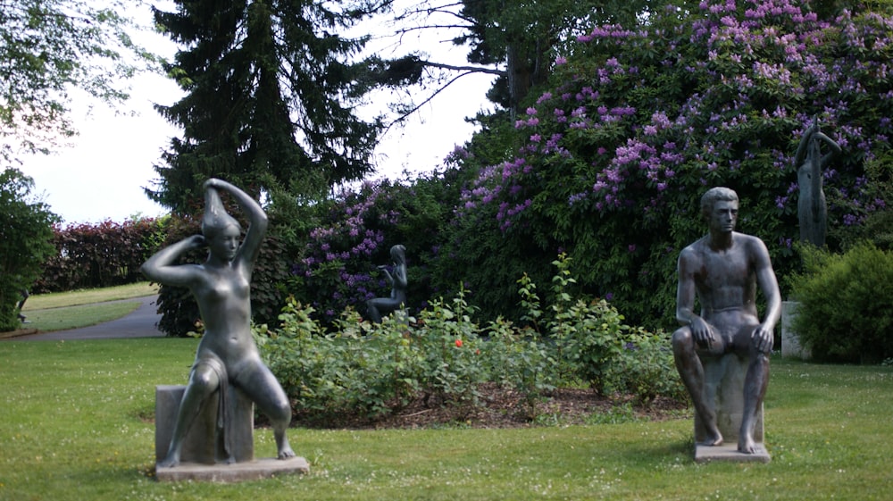 a statue of a man and a woman in a park