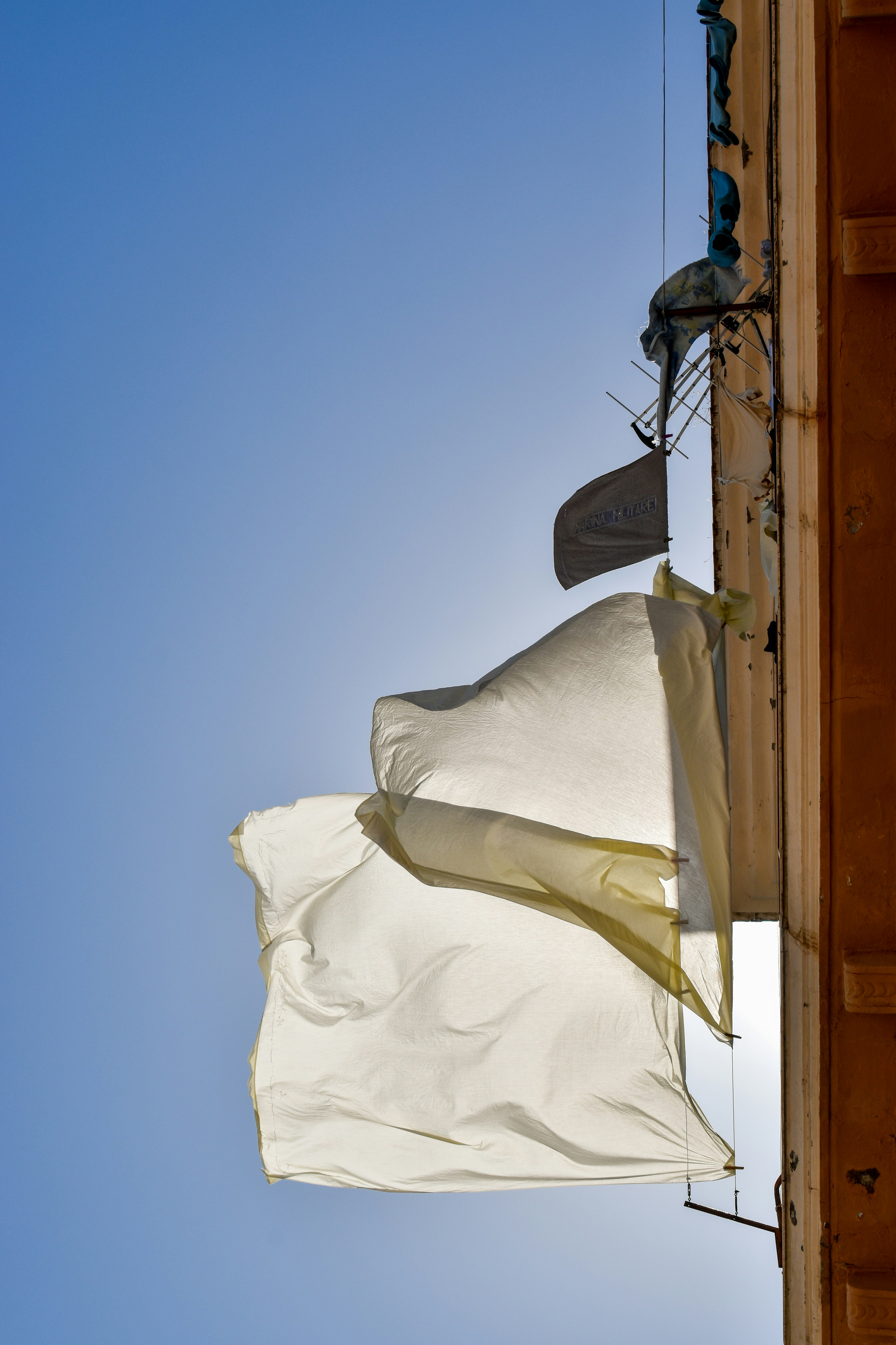 White sheets drying in the wind in Gaeta, Italy.