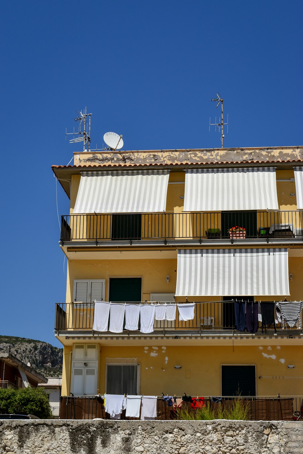 a yellow building with a balcony