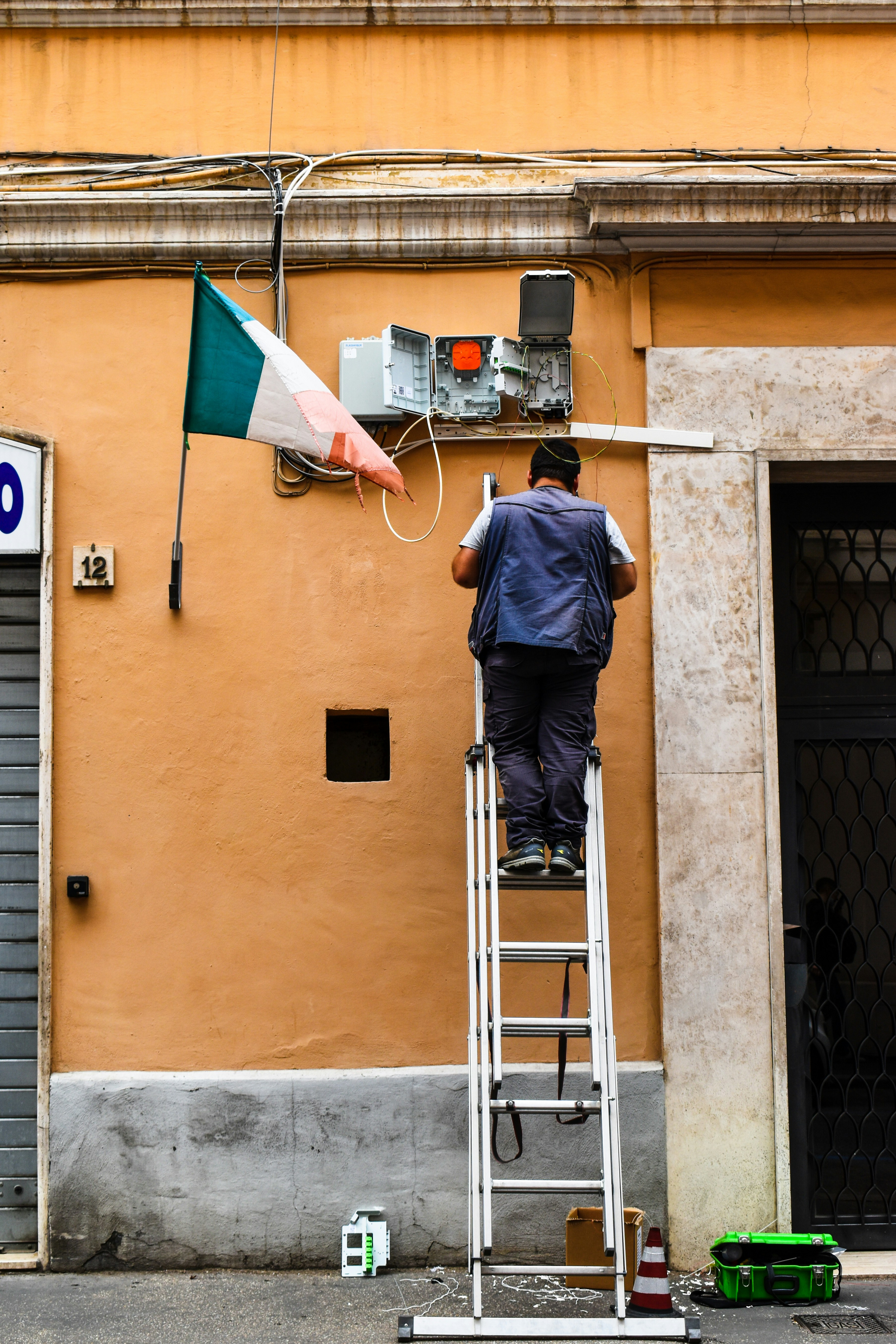 a man on a ladder holding a flag