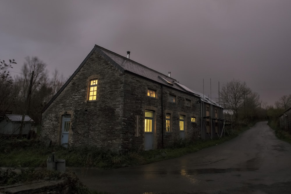 a stone building with windows and a road in front of it