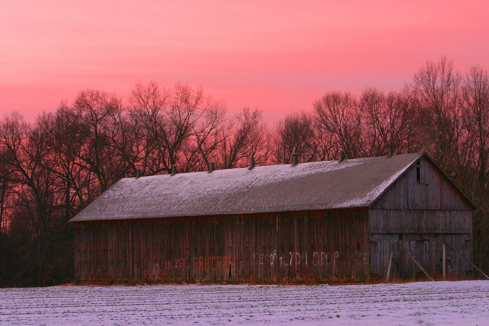 a barn in a snowy field