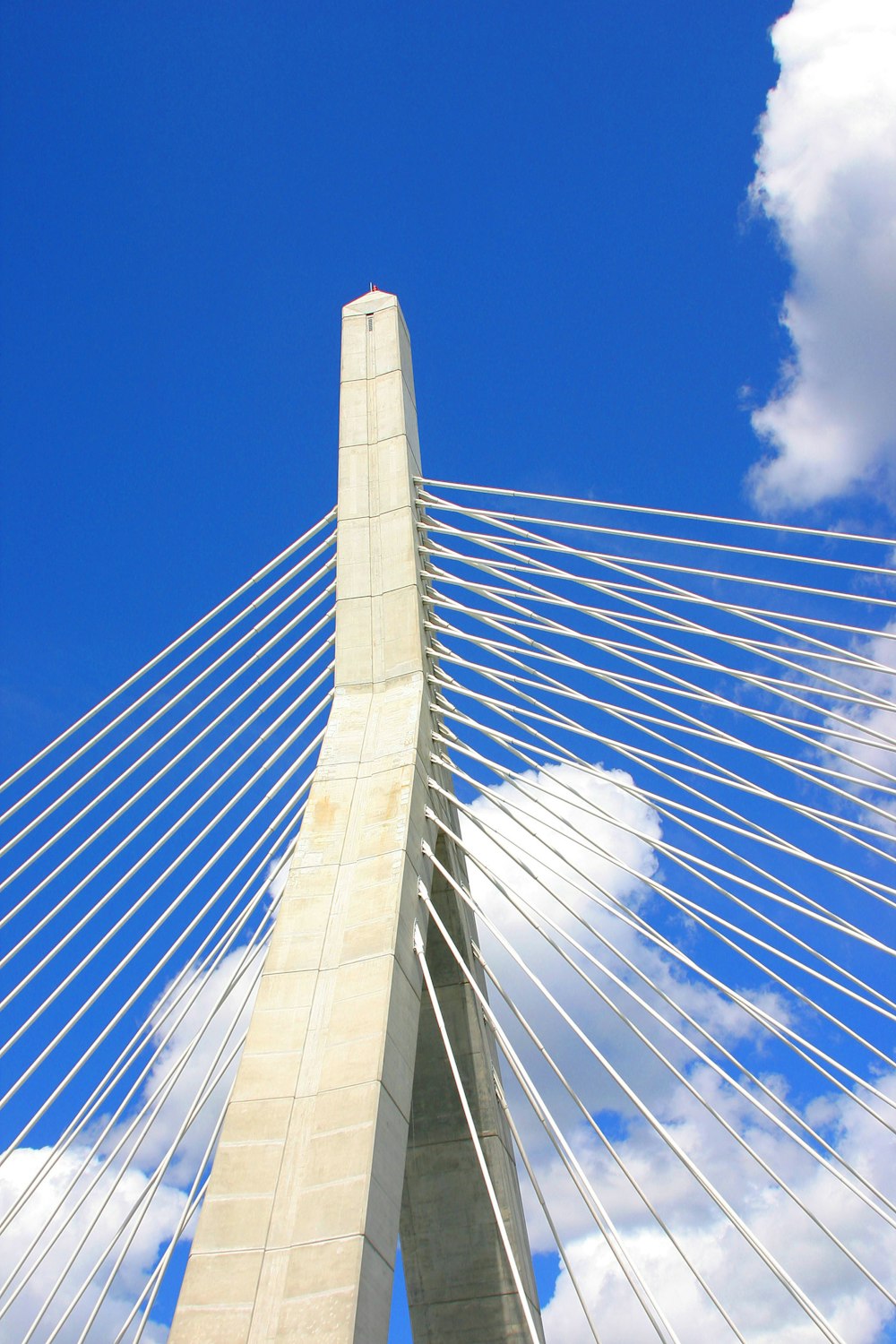 a tall bridge with cables with Leonard P. Zakim Bunker Hill Memorial Bridge in the background