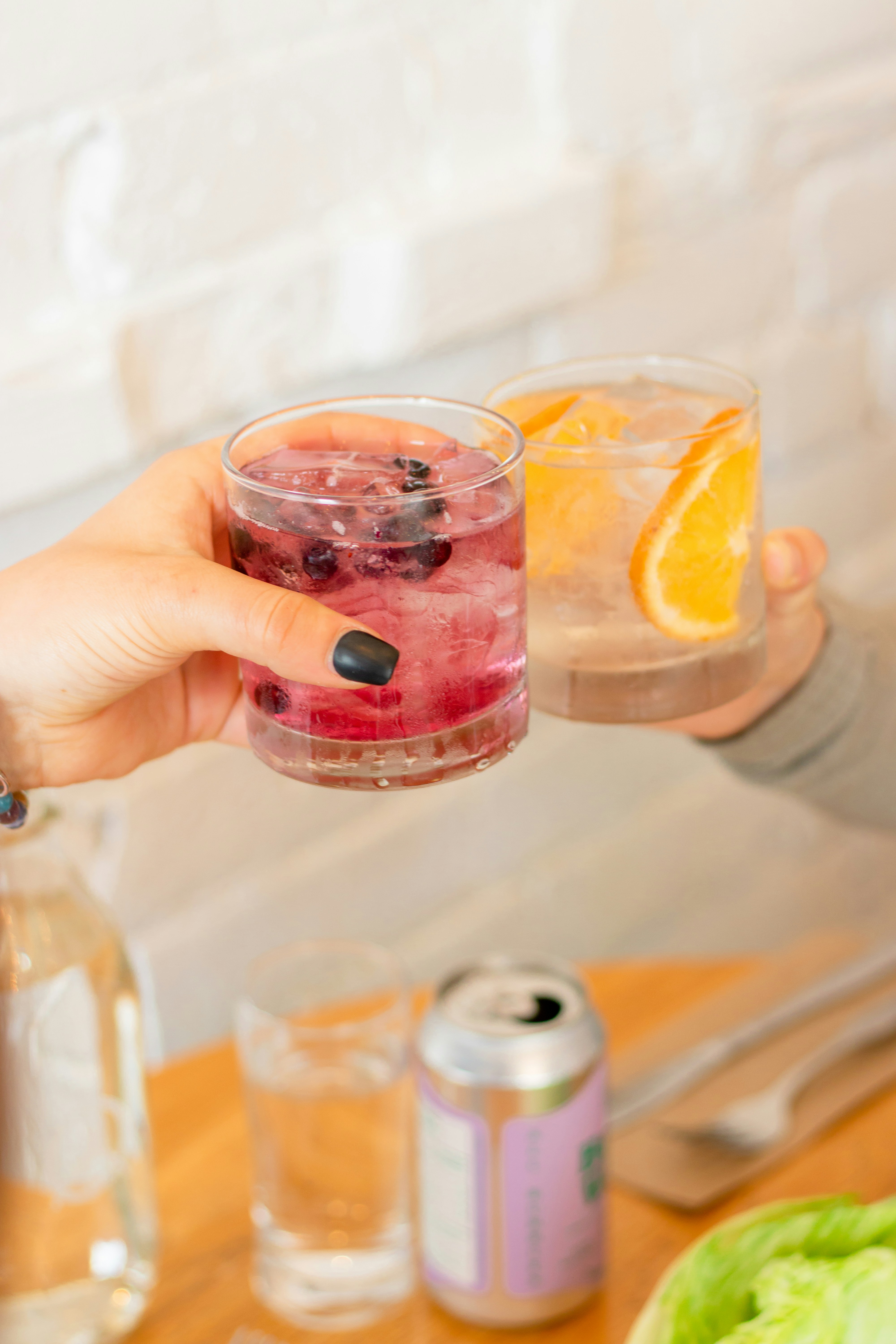a person pouring a drink into a glass