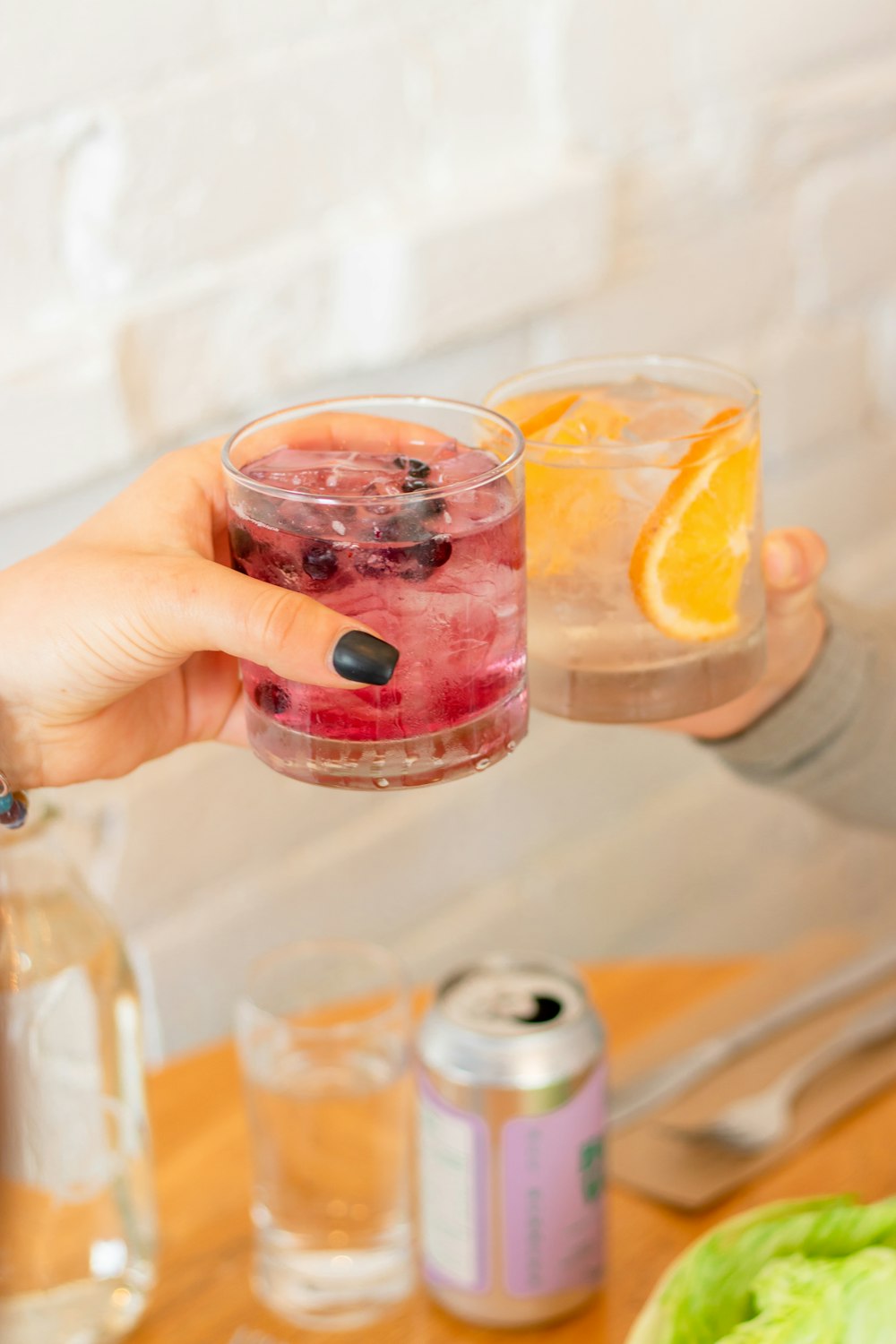 a person pouring a drink into a glass