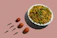 Close-up of a steaming bowl of vibrant Sichuan noodles garnished with fresh herbs.
