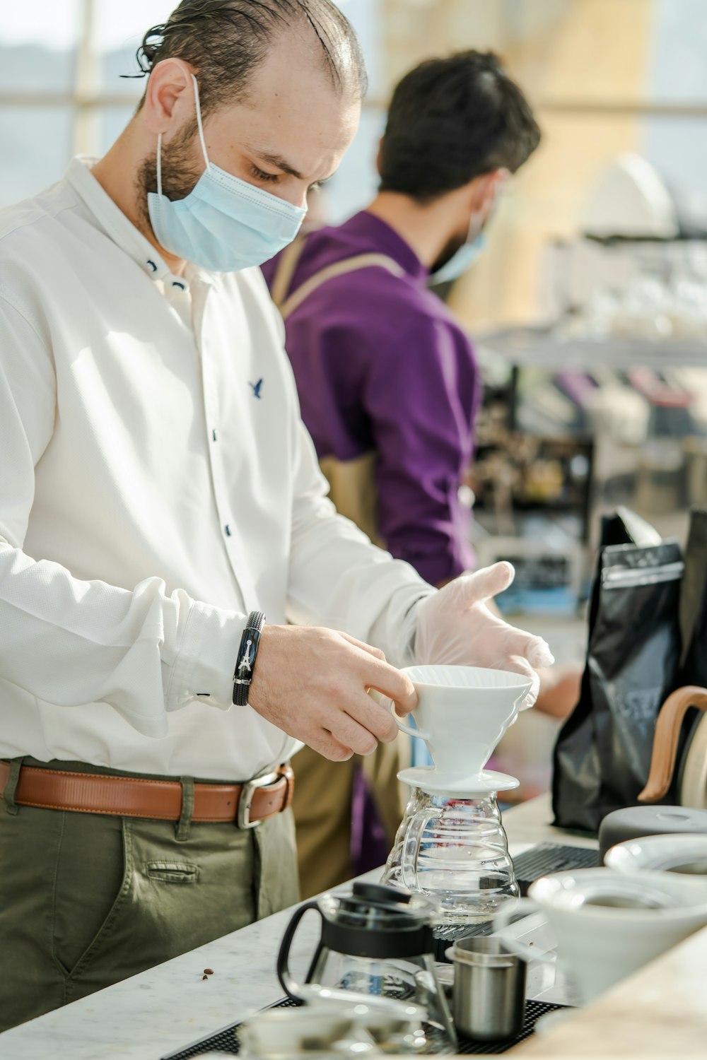 a person wearing a mask and gloves