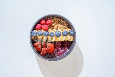 a bowl of cereal with milk and fruit