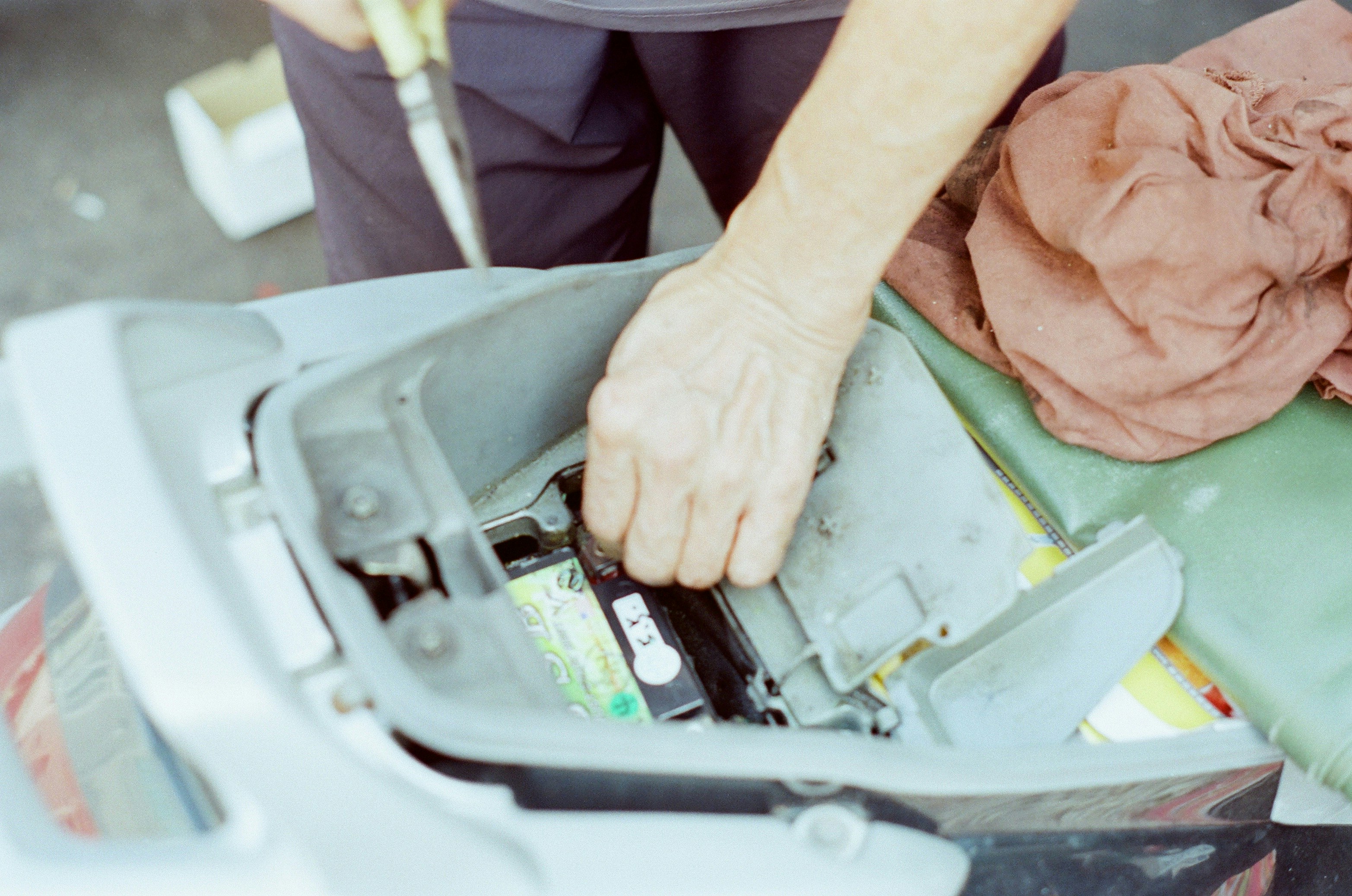Technician inspecting an electric vehicle battery pack on a lift in a service center