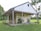 a white house with a grass yard