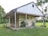 a white house with a grass yard