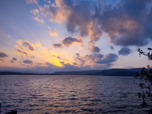 A scenic view of Lake Toba at sunset.