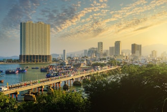 a bridge over a river with a city in the background