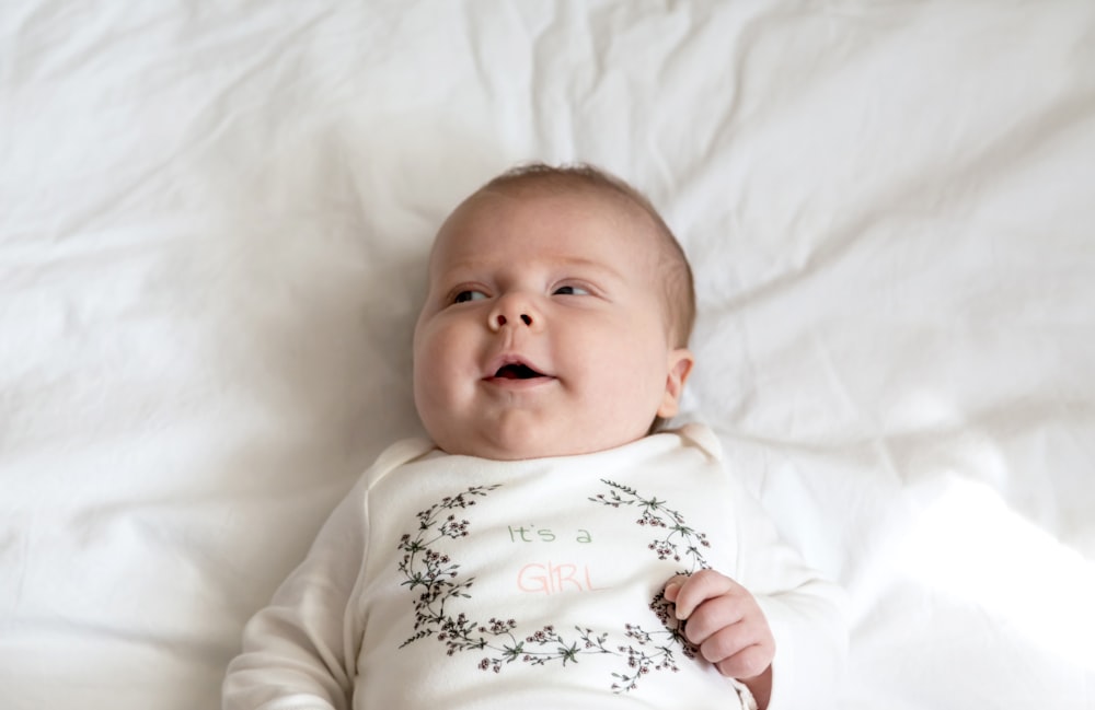 a baby lying on a bed