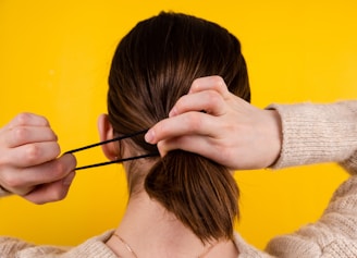 a person holding the head with the hands