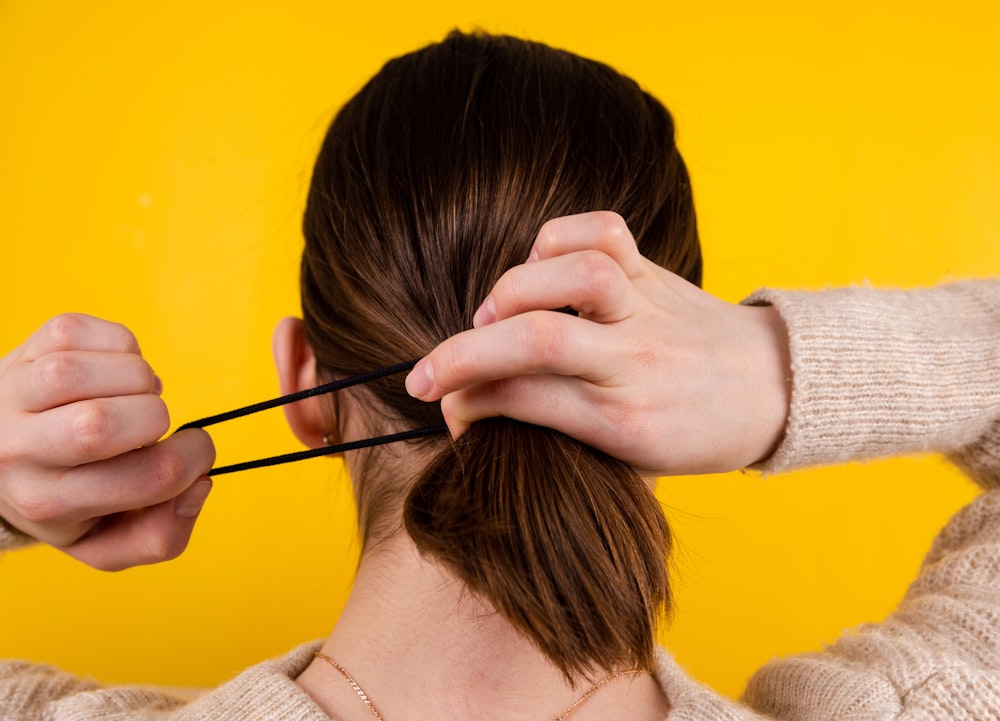 a person holding the head with the hands