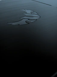 Sophisticated dark-themed workspace with a glowing gold emblem representing brand protection.