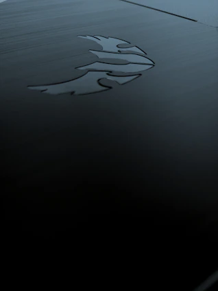 A sleek dark mode office space illuminated by polished bronze and gold accents, reflecting a high-tech, futuristic vibe.