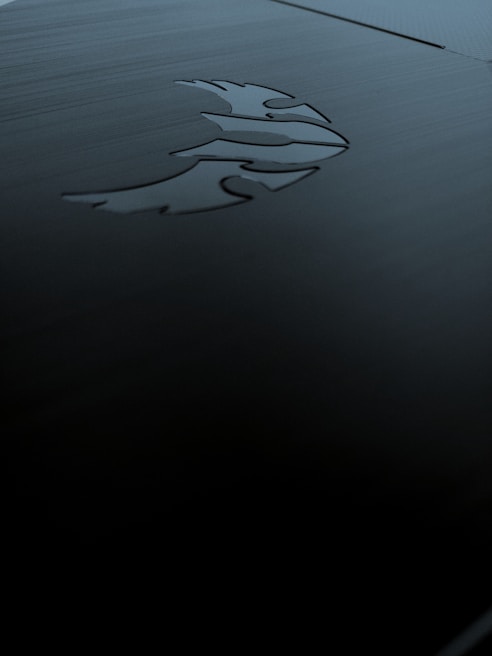 Sharp, precise diamond tip engraving on a sleek metal surface reflecting light