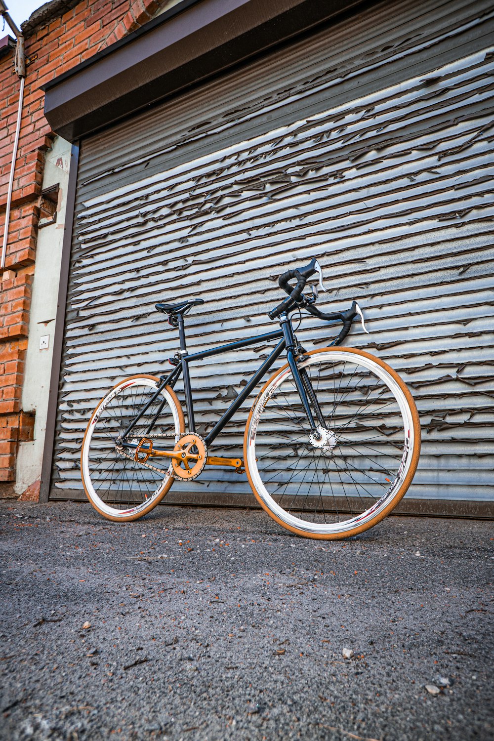 a bicycle parked in front of a garage door