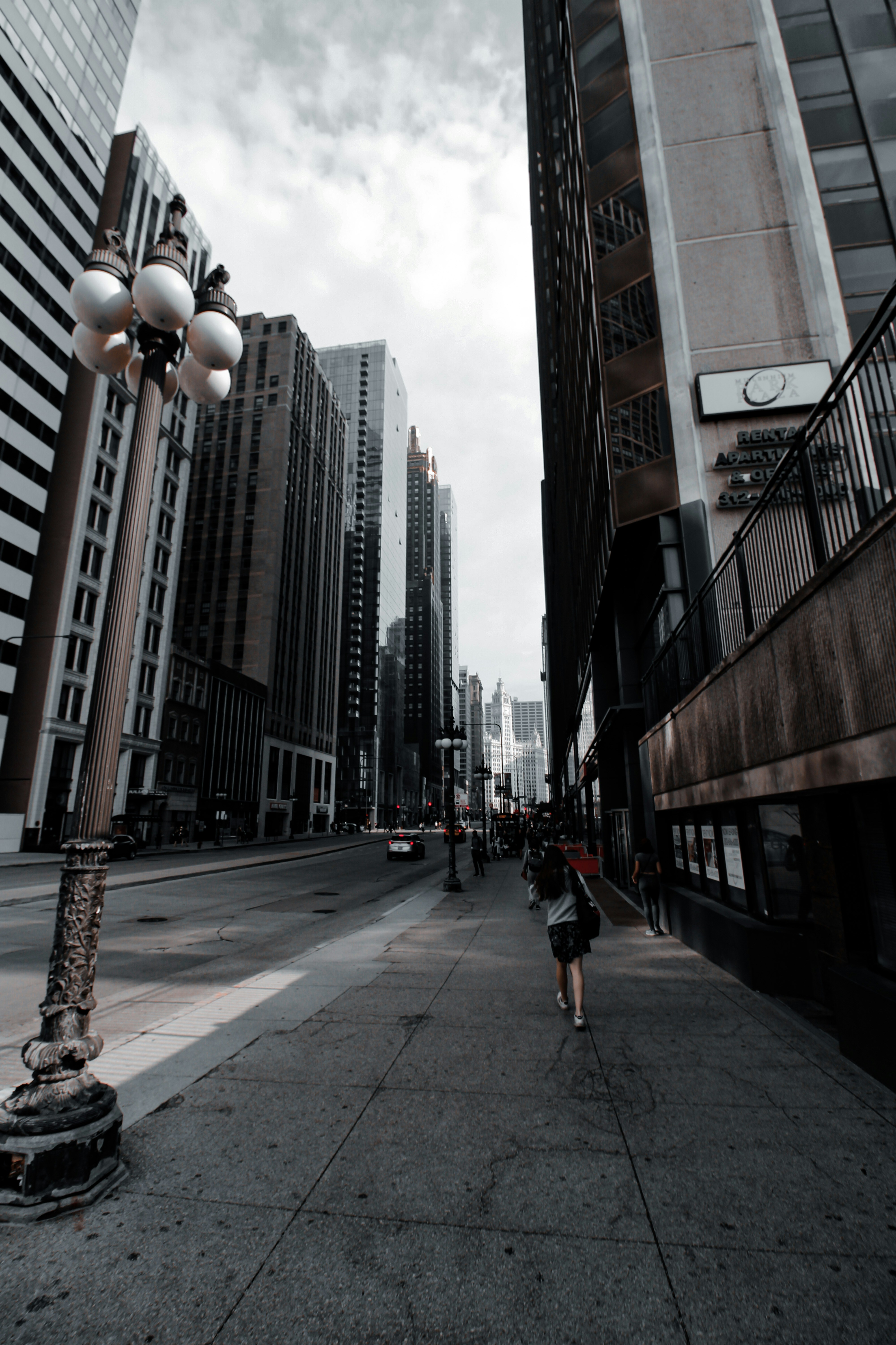 a person running on a sidewalk between buildings