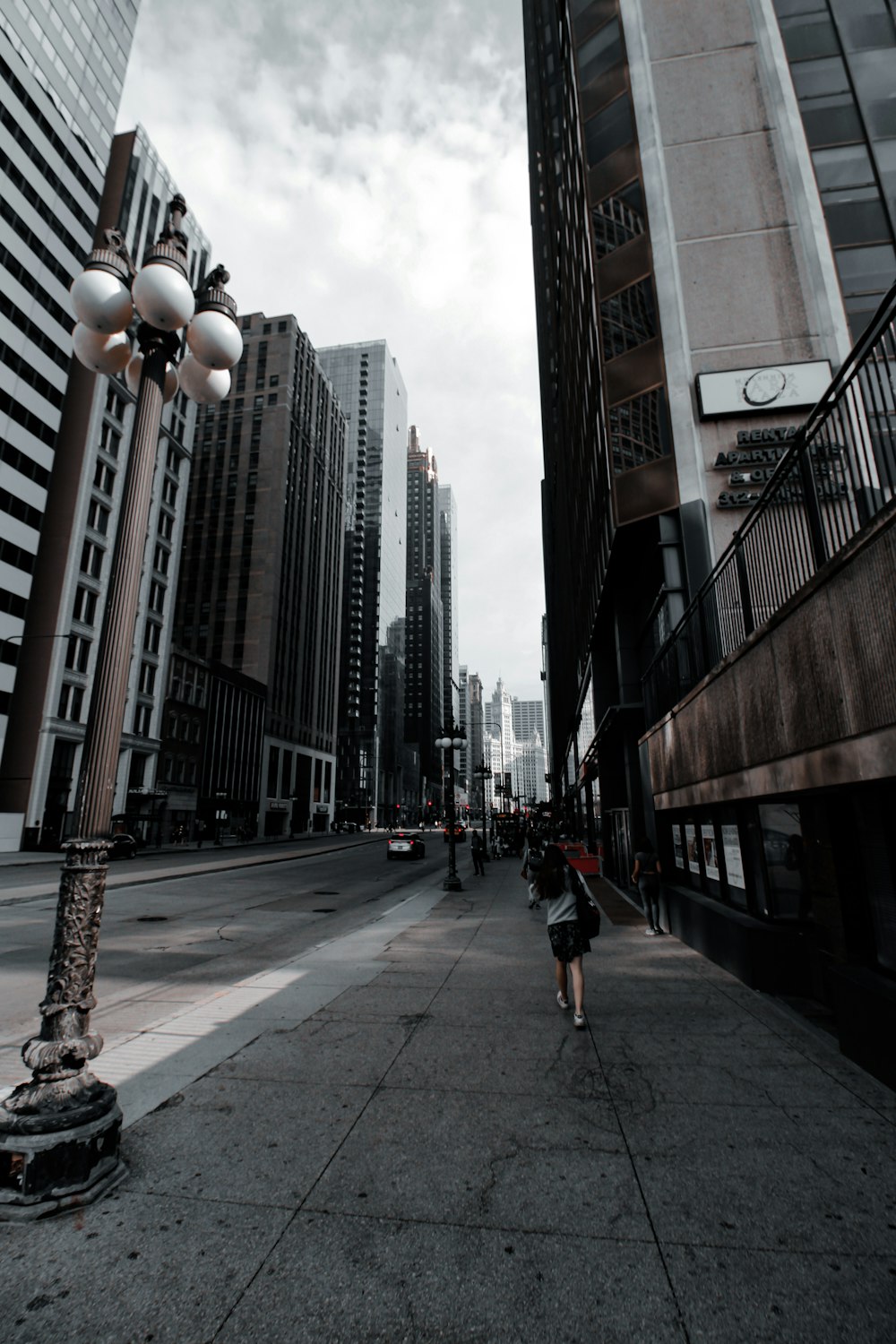 a person running on a sidewalk between buildings