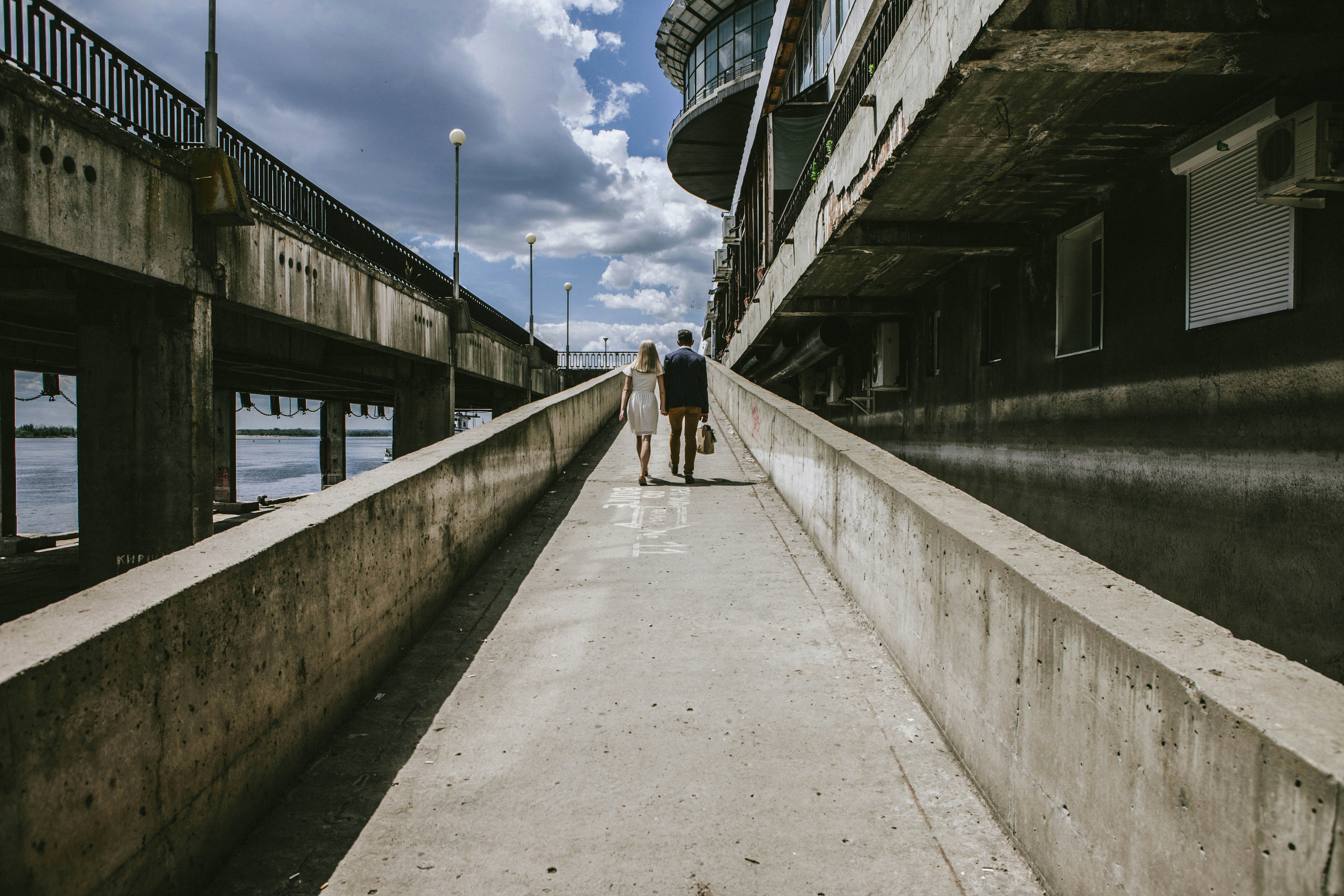 a couple walking on a bridge