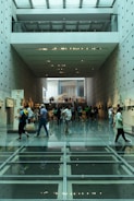 a group of people walking in a large building