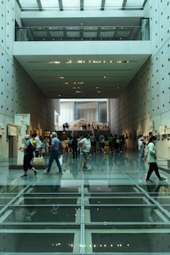 a group of people walking in a large building