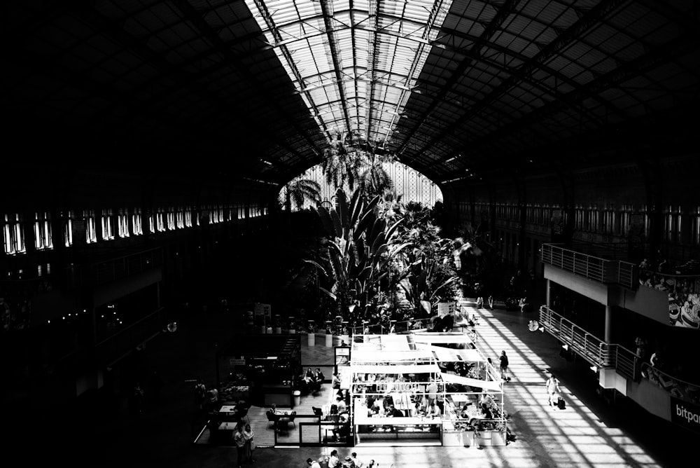 a large room with a large tree and people in it