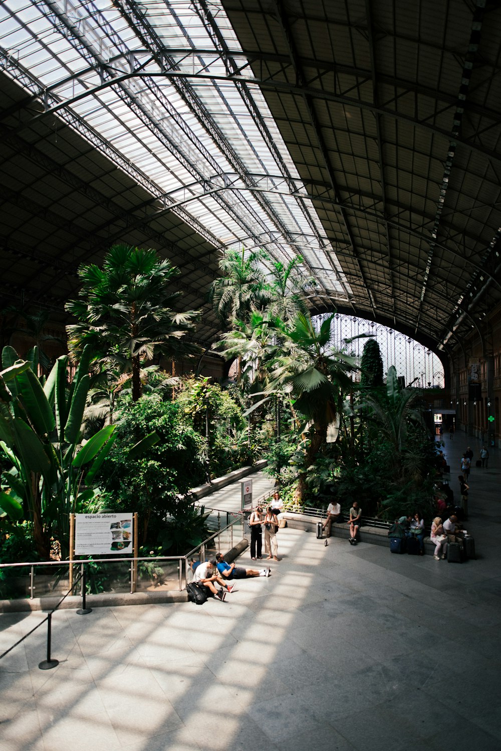 a group of people in a large indoor garden