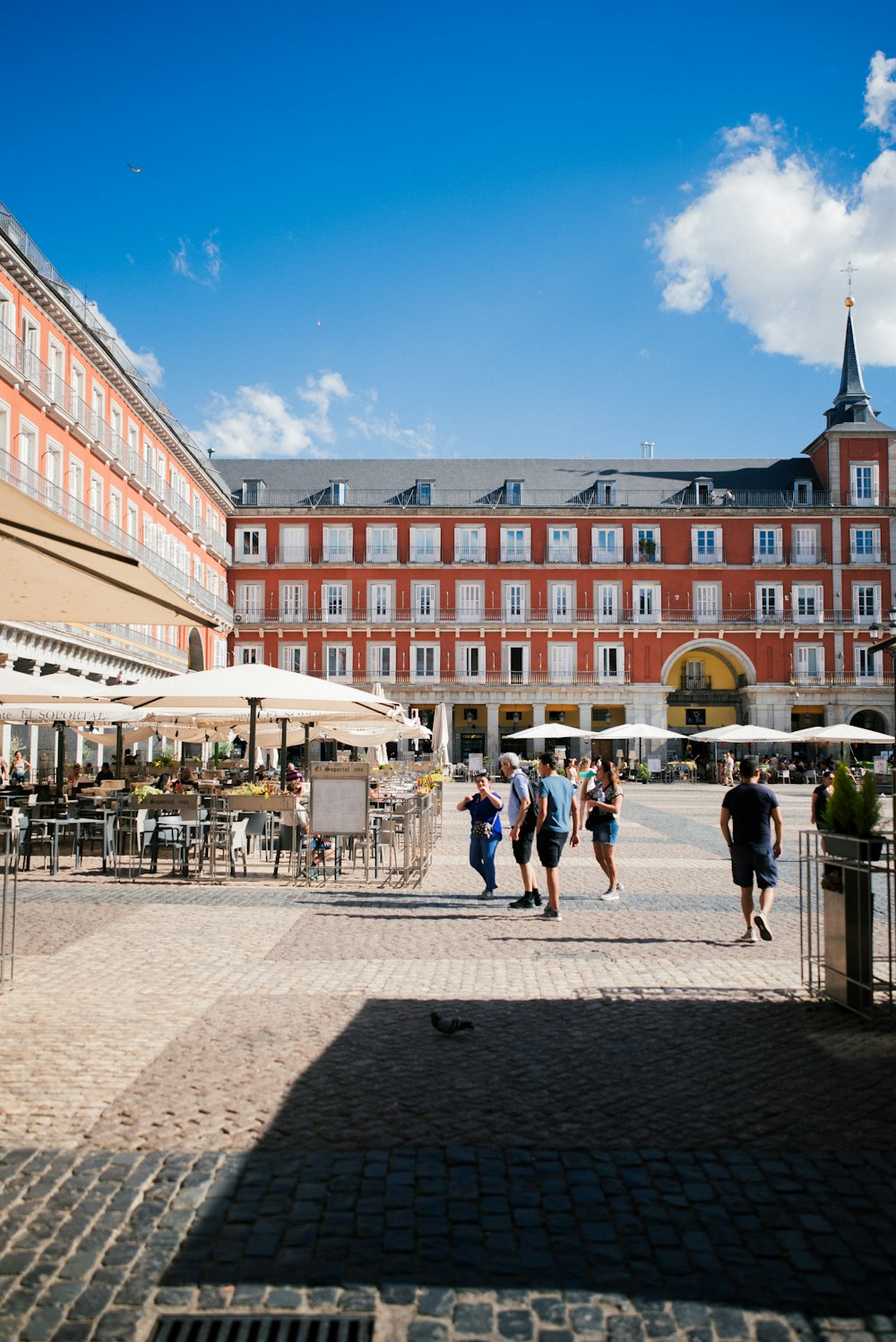 people walking on a brick walkway