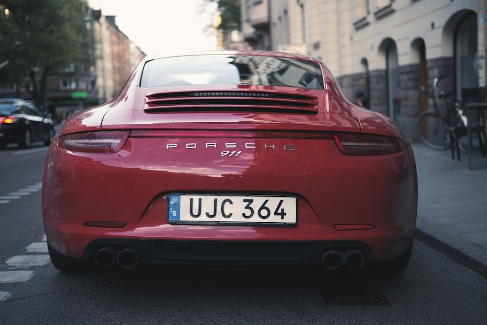 a red car parked on the side of a street