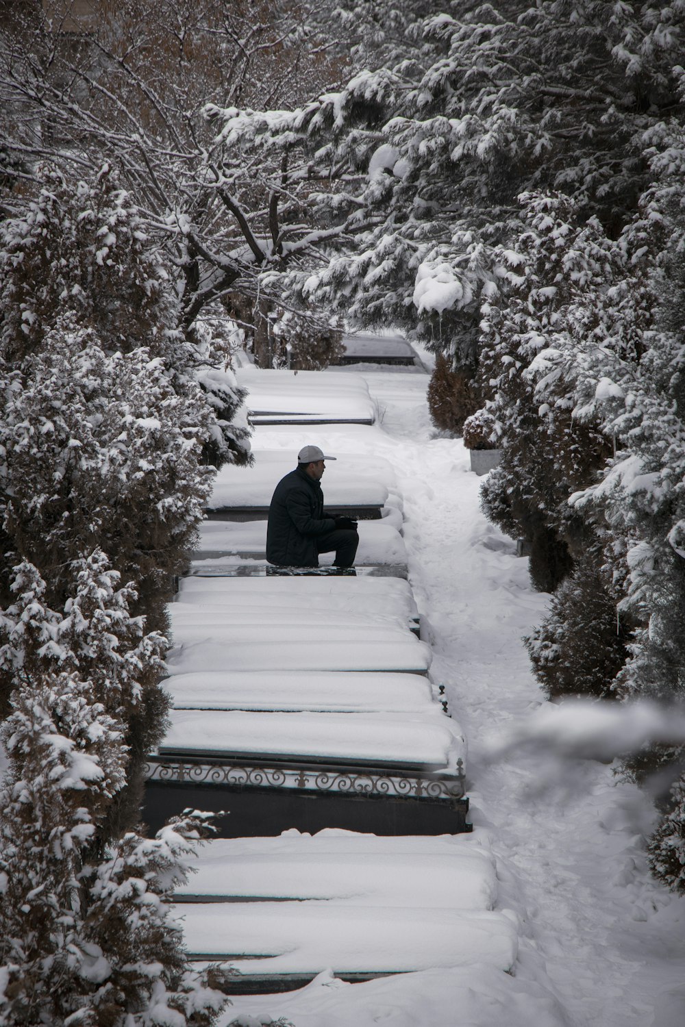 a person sitting on a bench in the snow