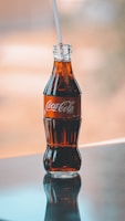 a glass bottle with a straw