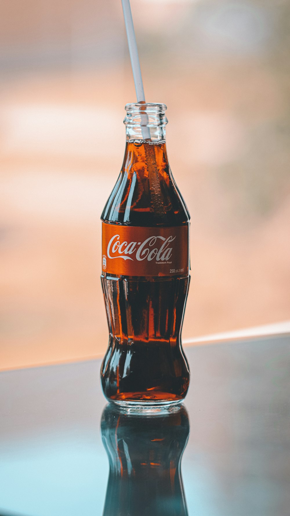 a glass bottle with a straw