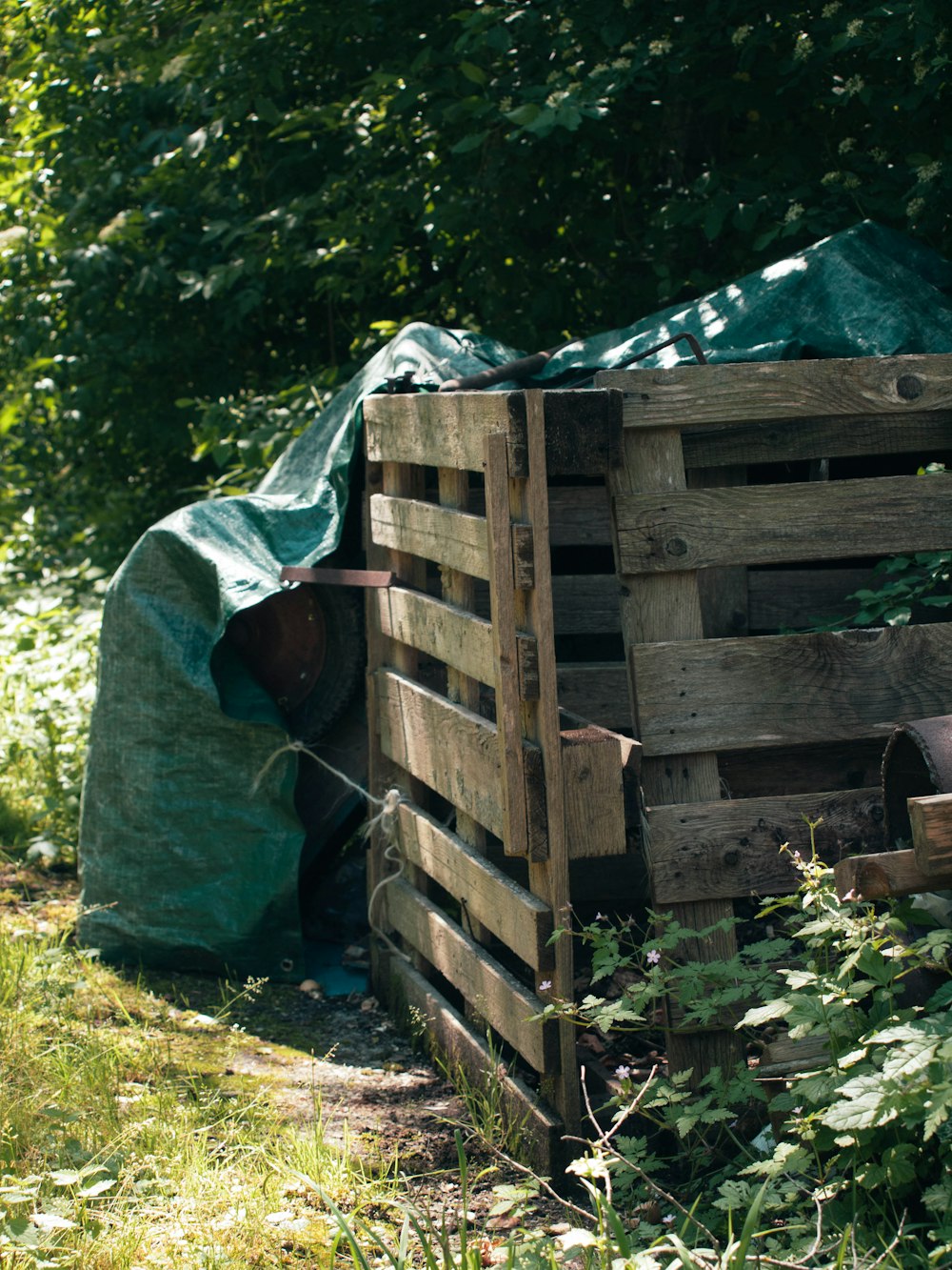 a person in a green bag next to a wooden structure