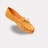 A tan suede loafer with a tassel decoration and a small bow on the upper. The shoe has detailed stitching along the edges and a low wooden heel.