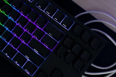A sleek mechanical keyboard with customizable RGB lighting glowing in a cozy workspace.