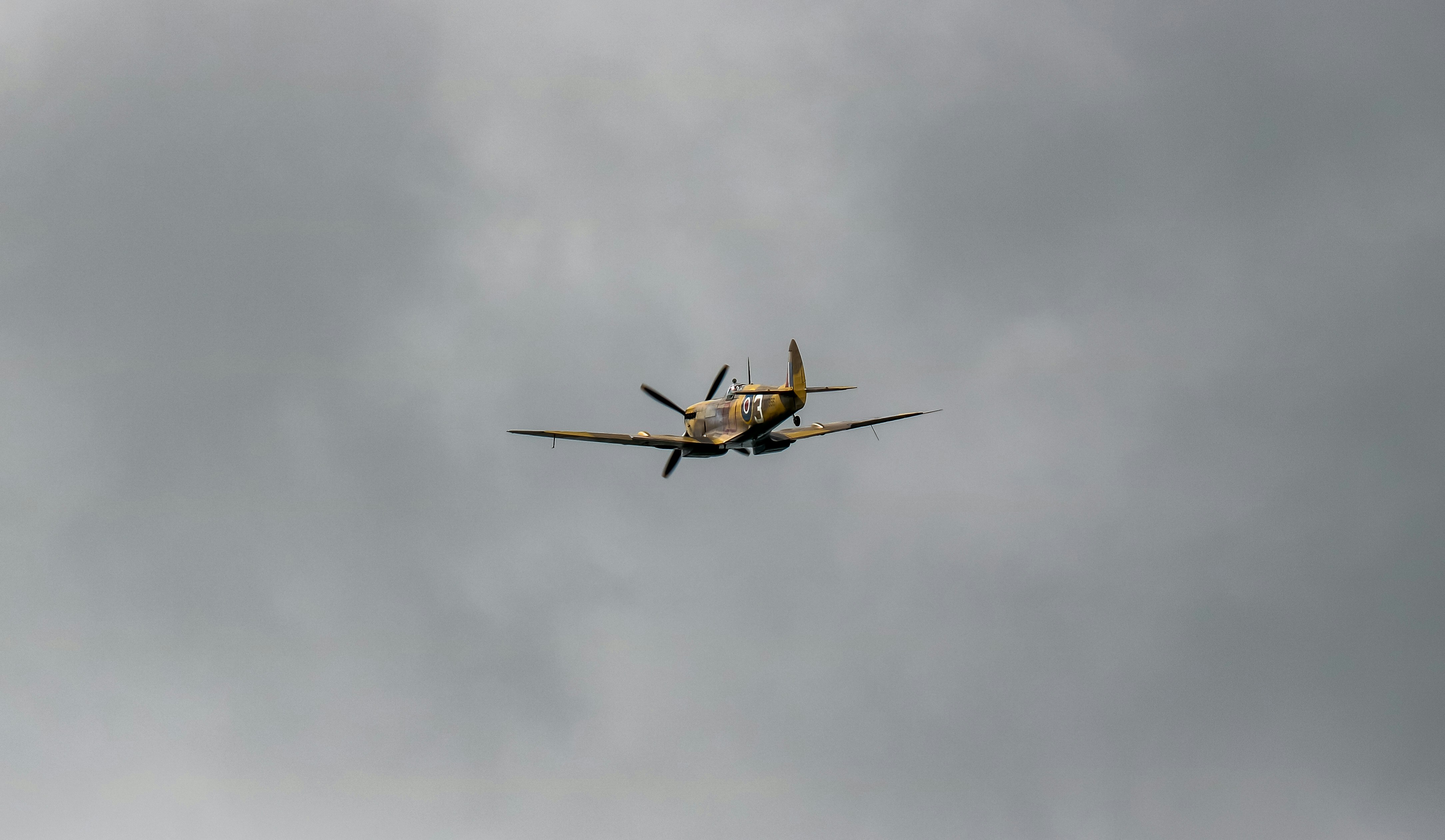 a helicopter flying in the sky, WWII Spitfire flyby at the Stonor Park supercar and classics day