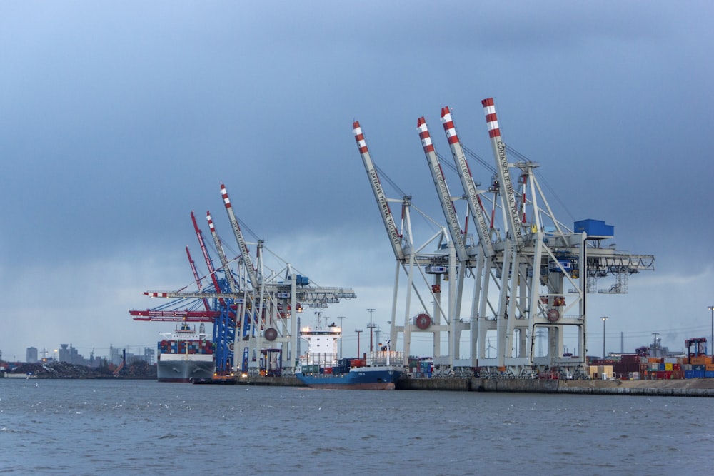 a group of cranes on a dock