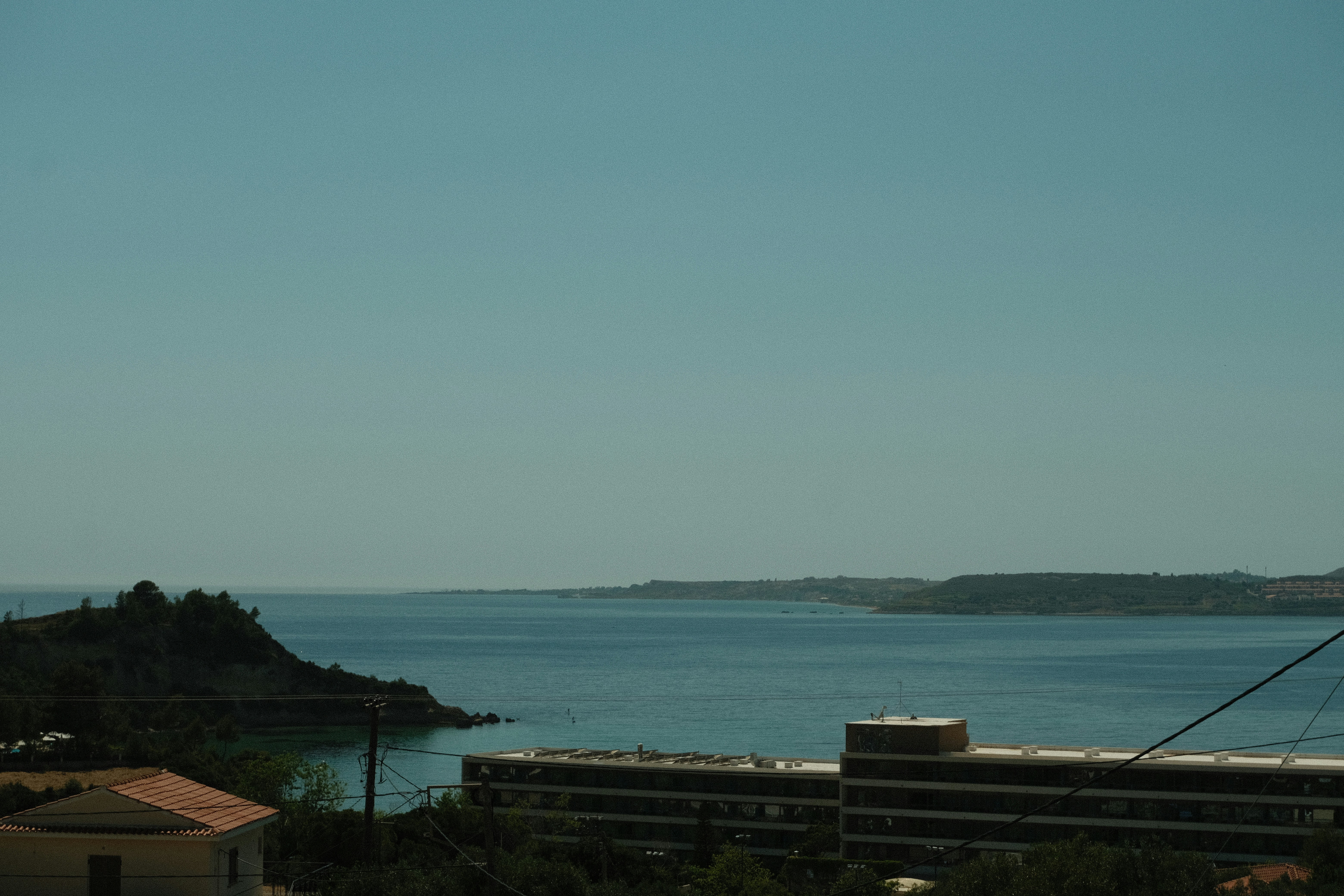 a body of water with buildings and trees around it