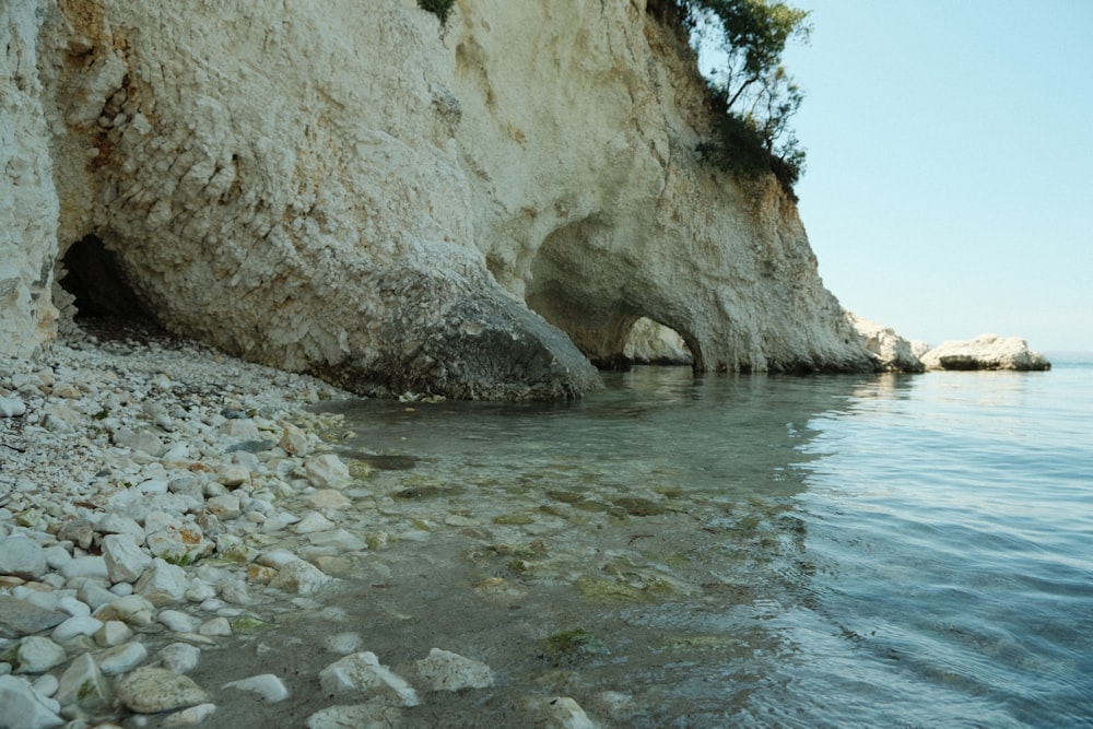a rocky beach with a cave