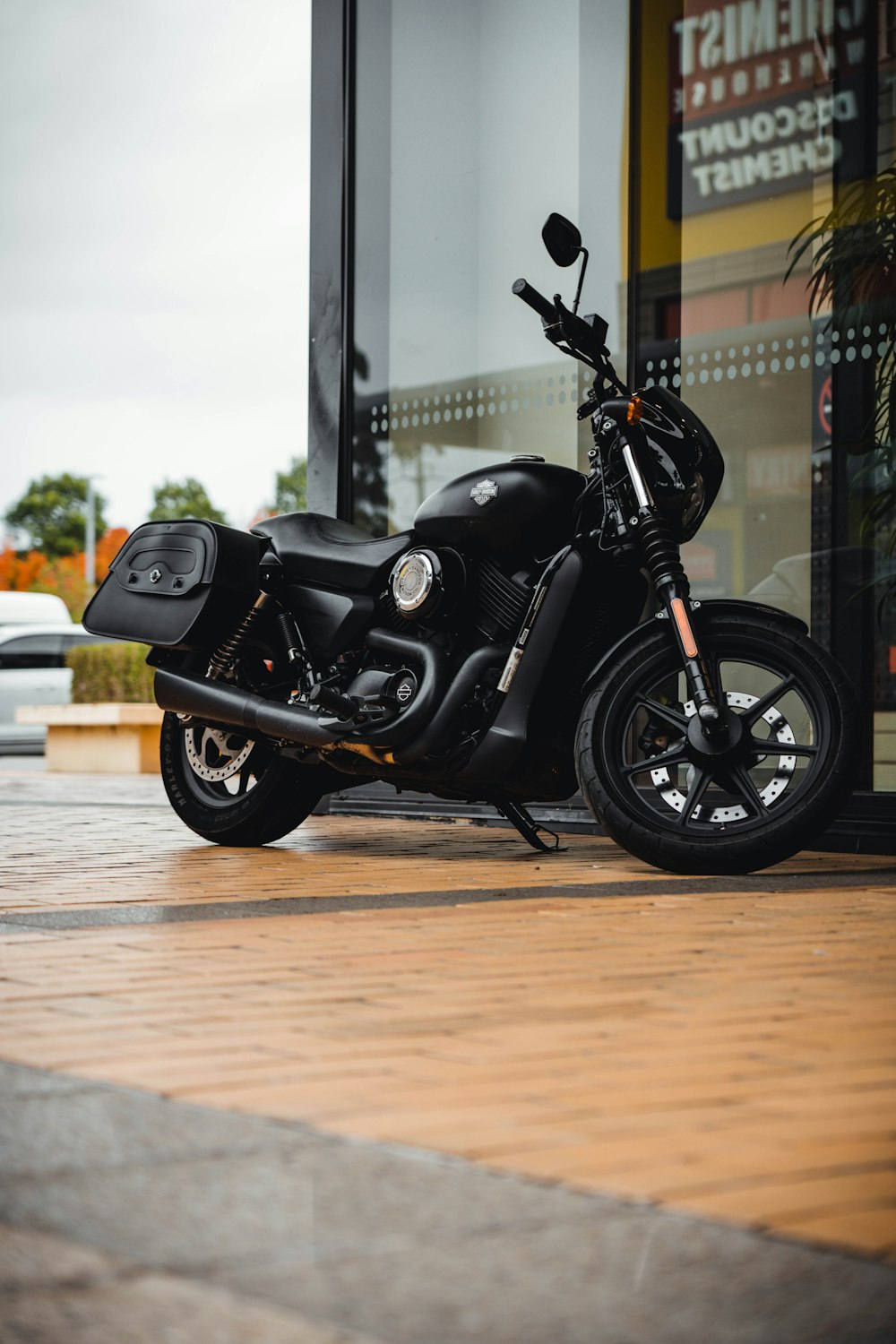 a black motorcycle parked on a sidewalk