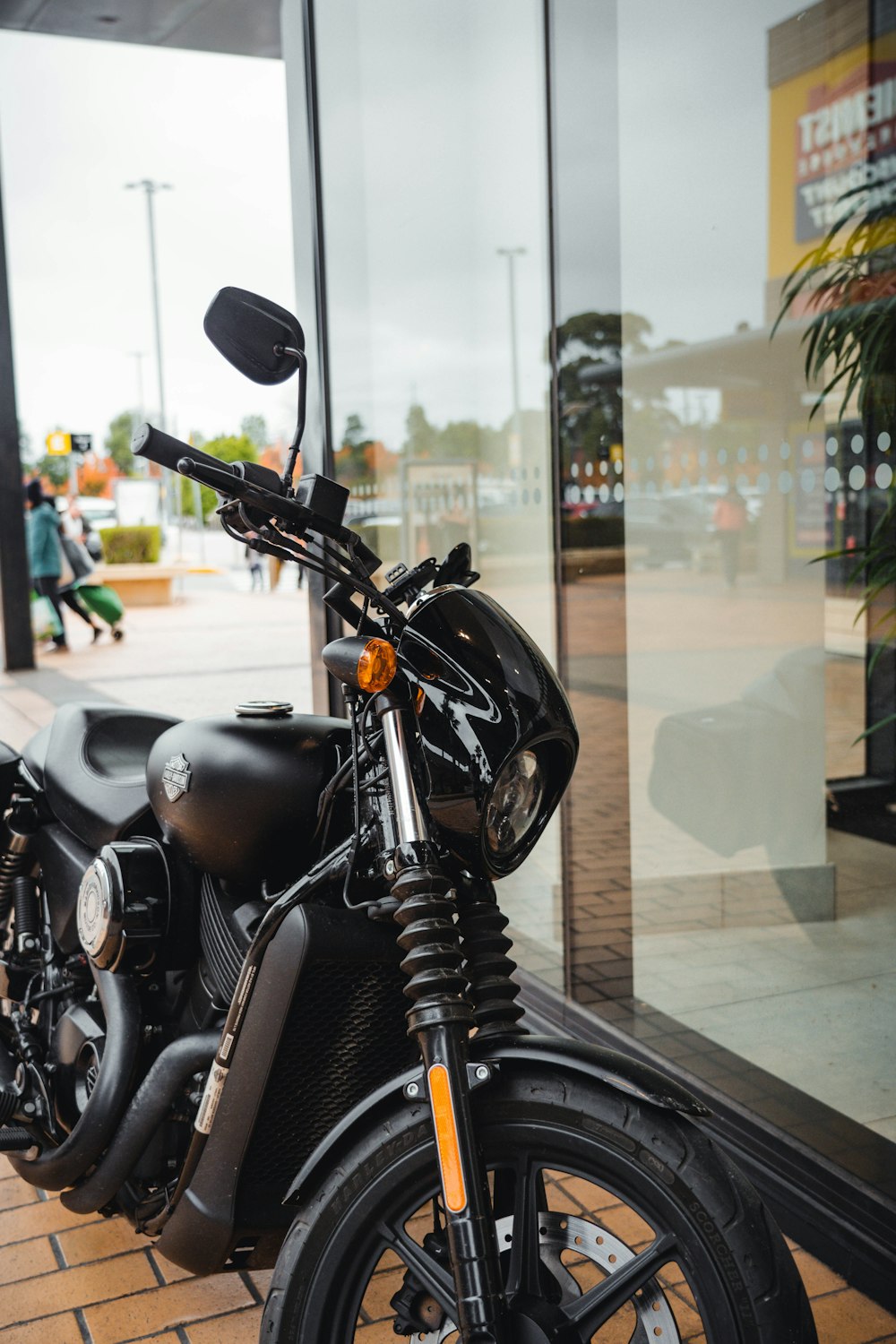 a motorcycle is parked in front of a glass door