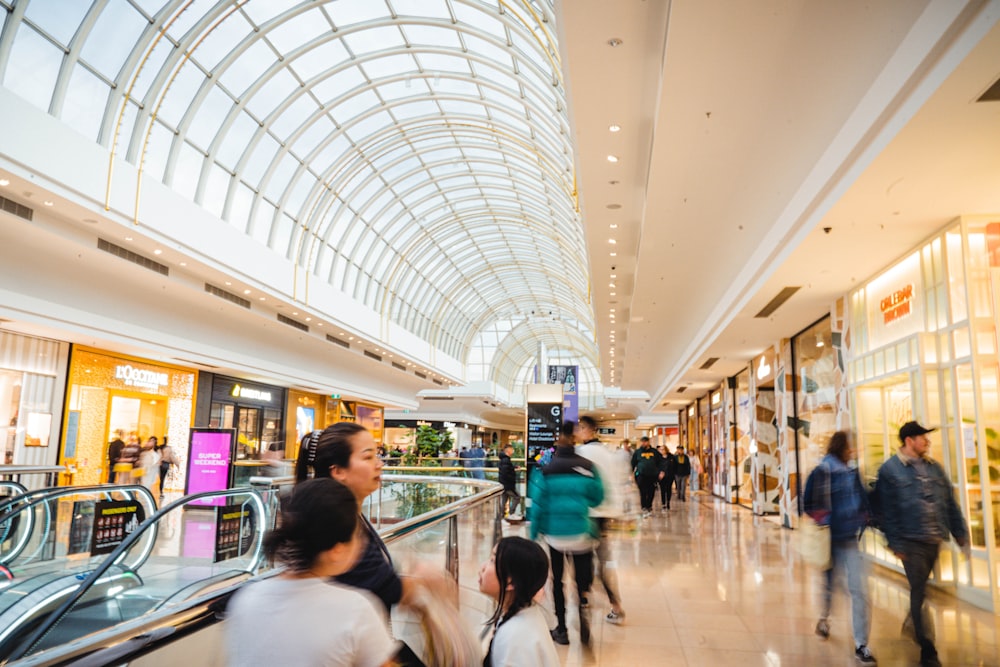 a group of people walking through a mall