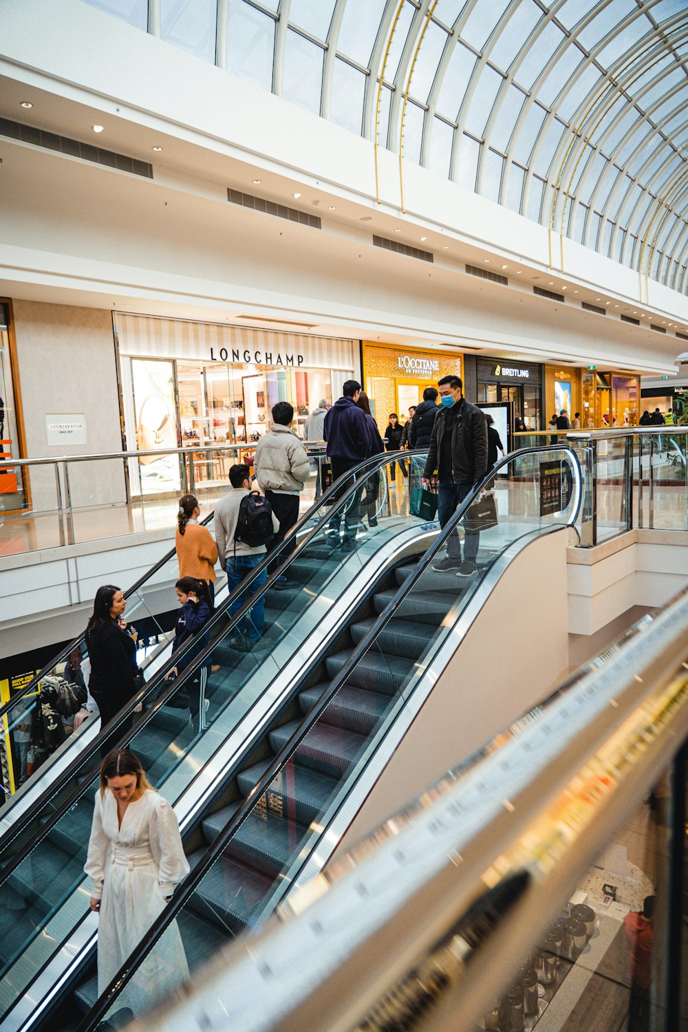 people walking down a flight of escalators