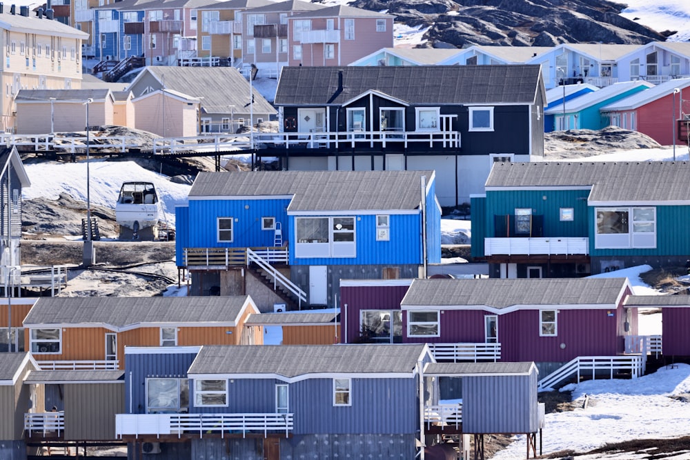 a group of buildings with mountains in the background